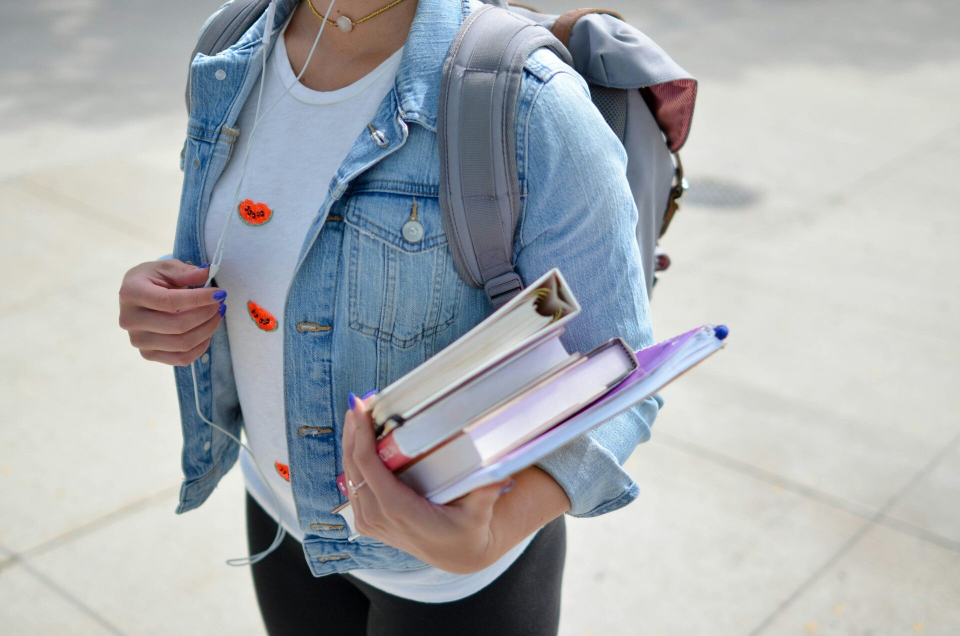 a photo of a student with a backpack and books, illustrating back to school wellness tips