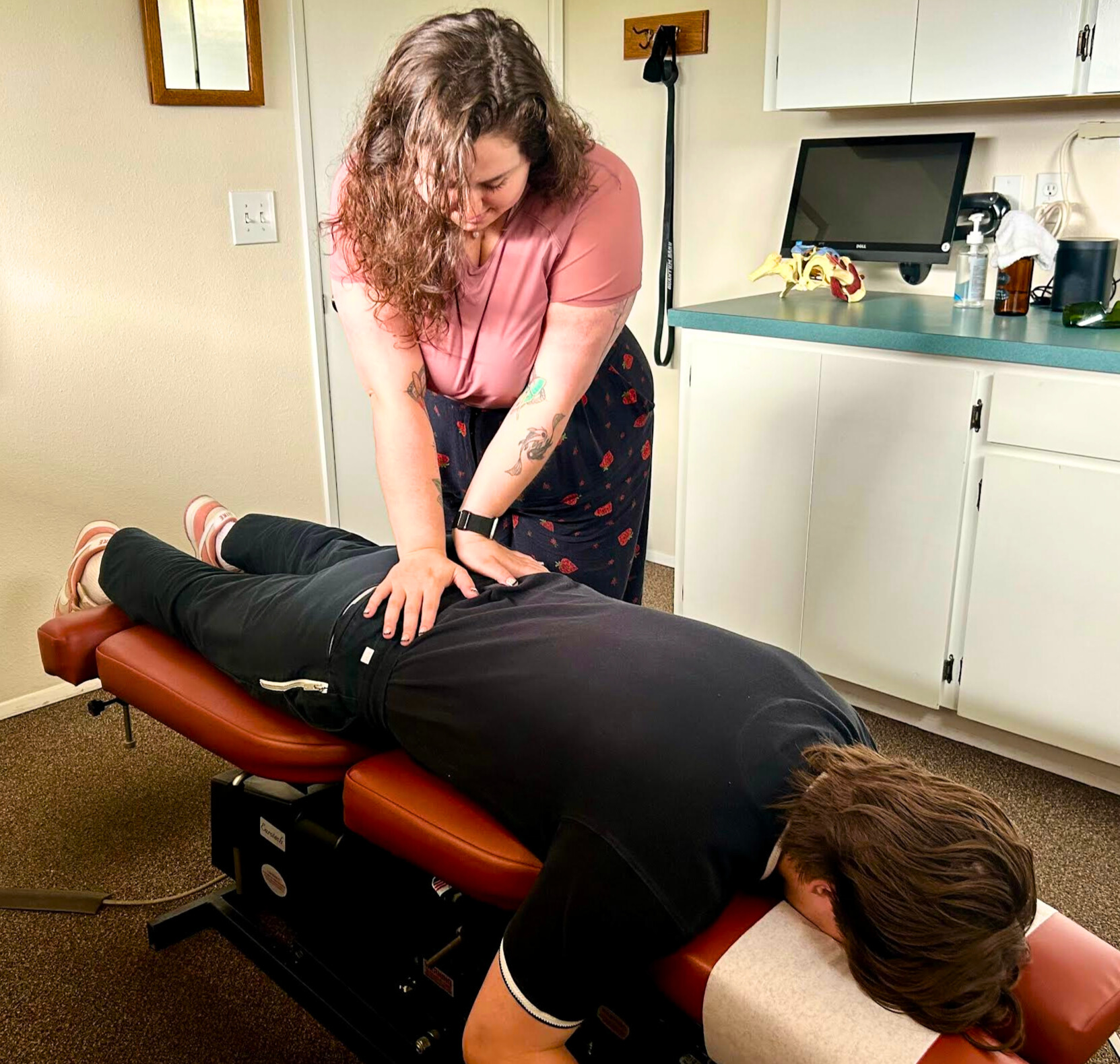 a photo of Dr. Renata Retter from Hosmer Chiropractic performing a chiropractic adjustment to help a patient find relief from sciatica pain